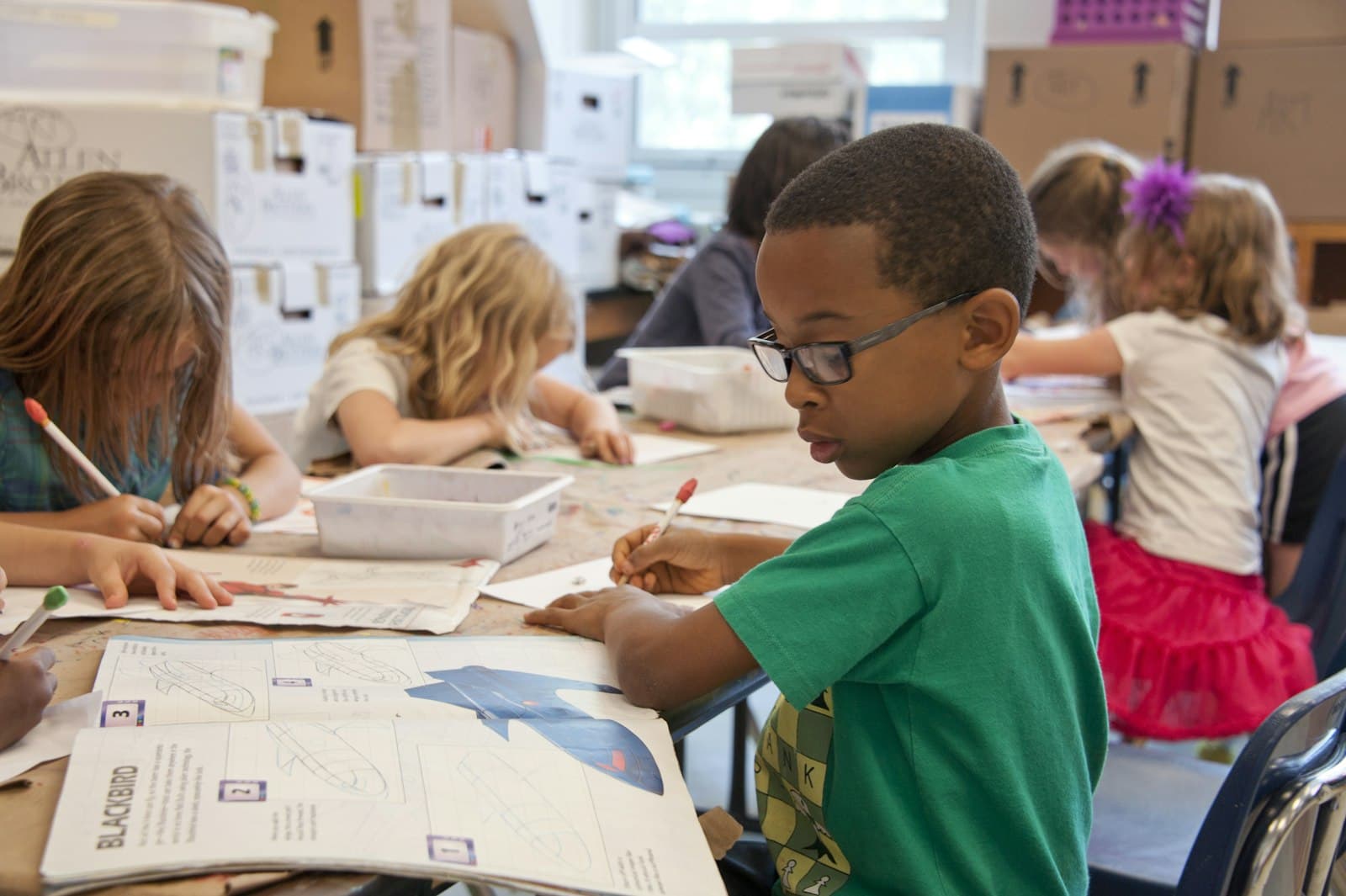Children learning to code on laptops in a classroom